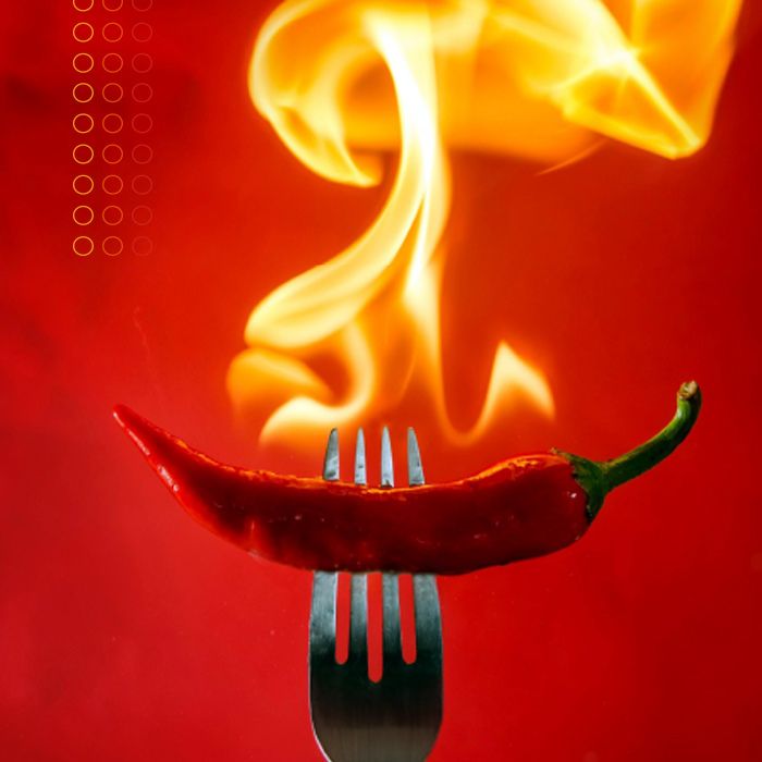 flaming whole chili pepper on a fork