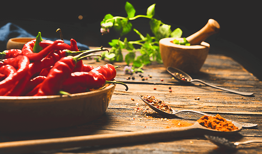 Bowl of chili peppers on a wood counter